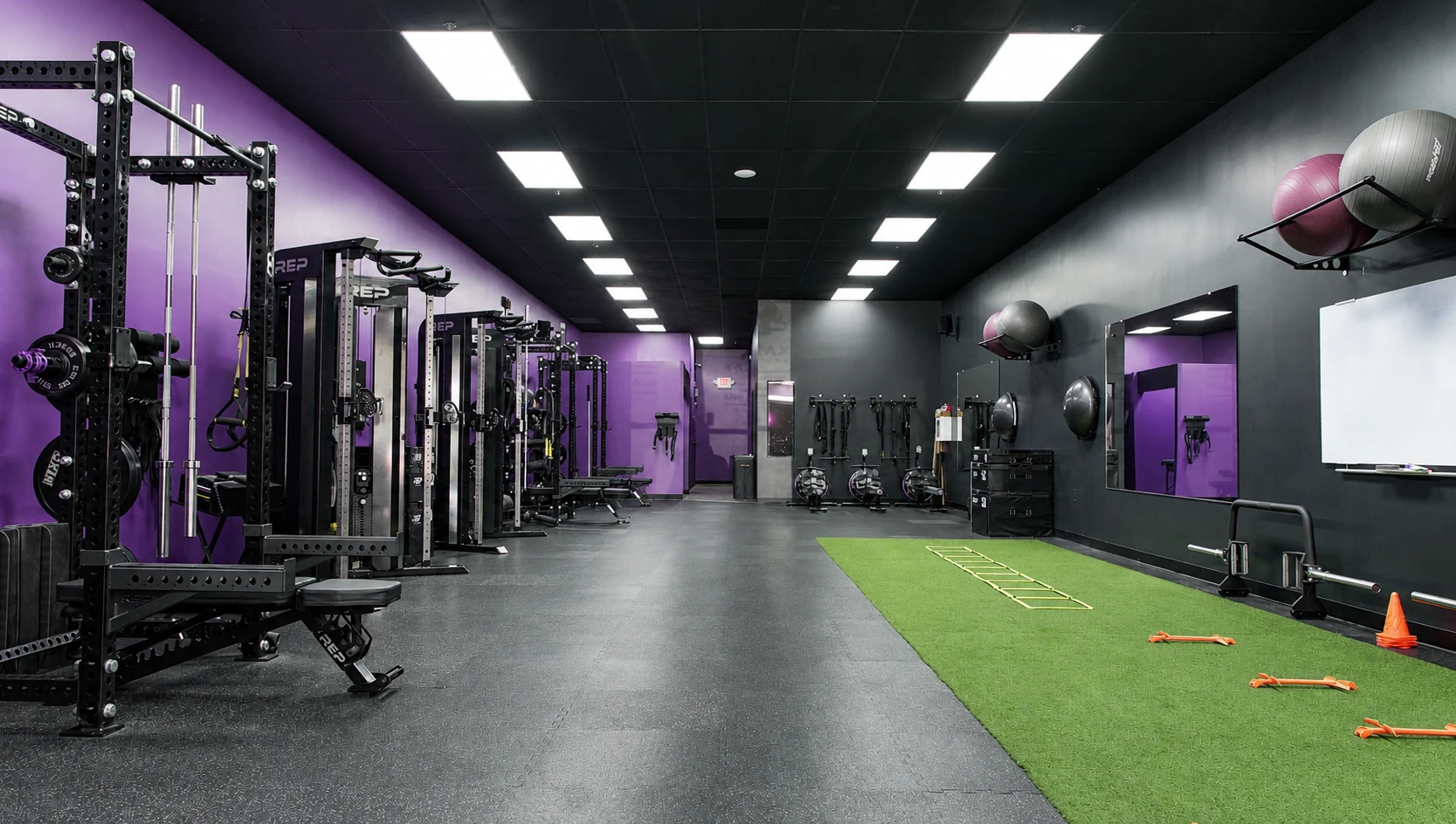 Full view of REP Fitness squat racks, cable machines, and turf area at Galaxy Fit Lab North Naples gym