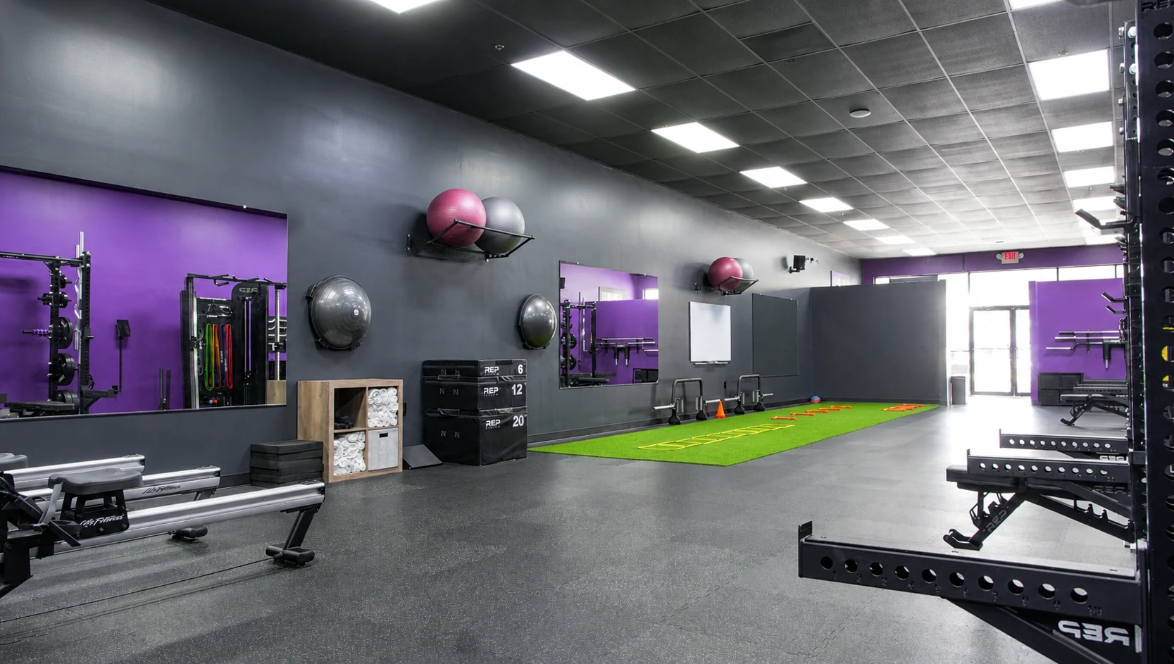 Open training floor with rowers, plyo boxes, and mirrored wall at Galaxy Fit Lab in Naples Florida